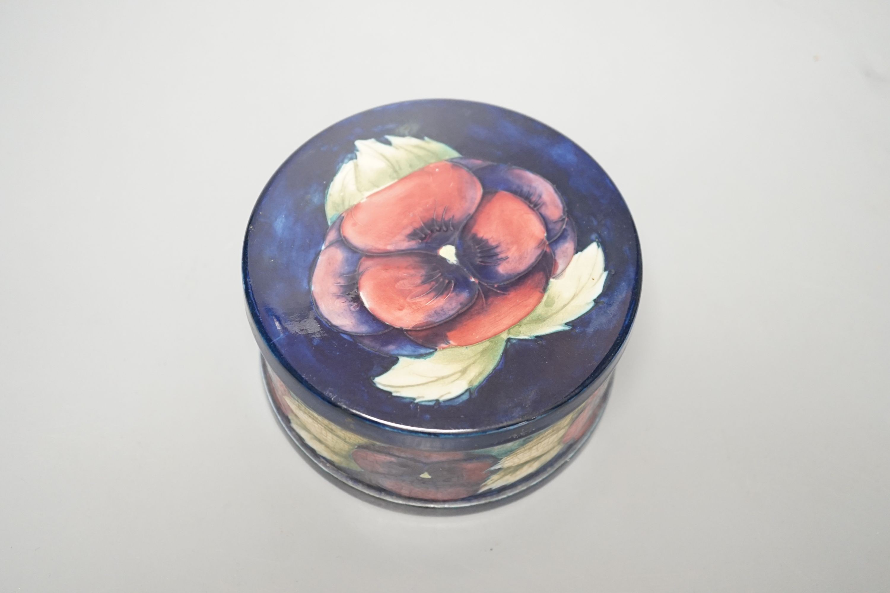 A Moorcroft pansy pattern circular box and cover, diameter 12cm